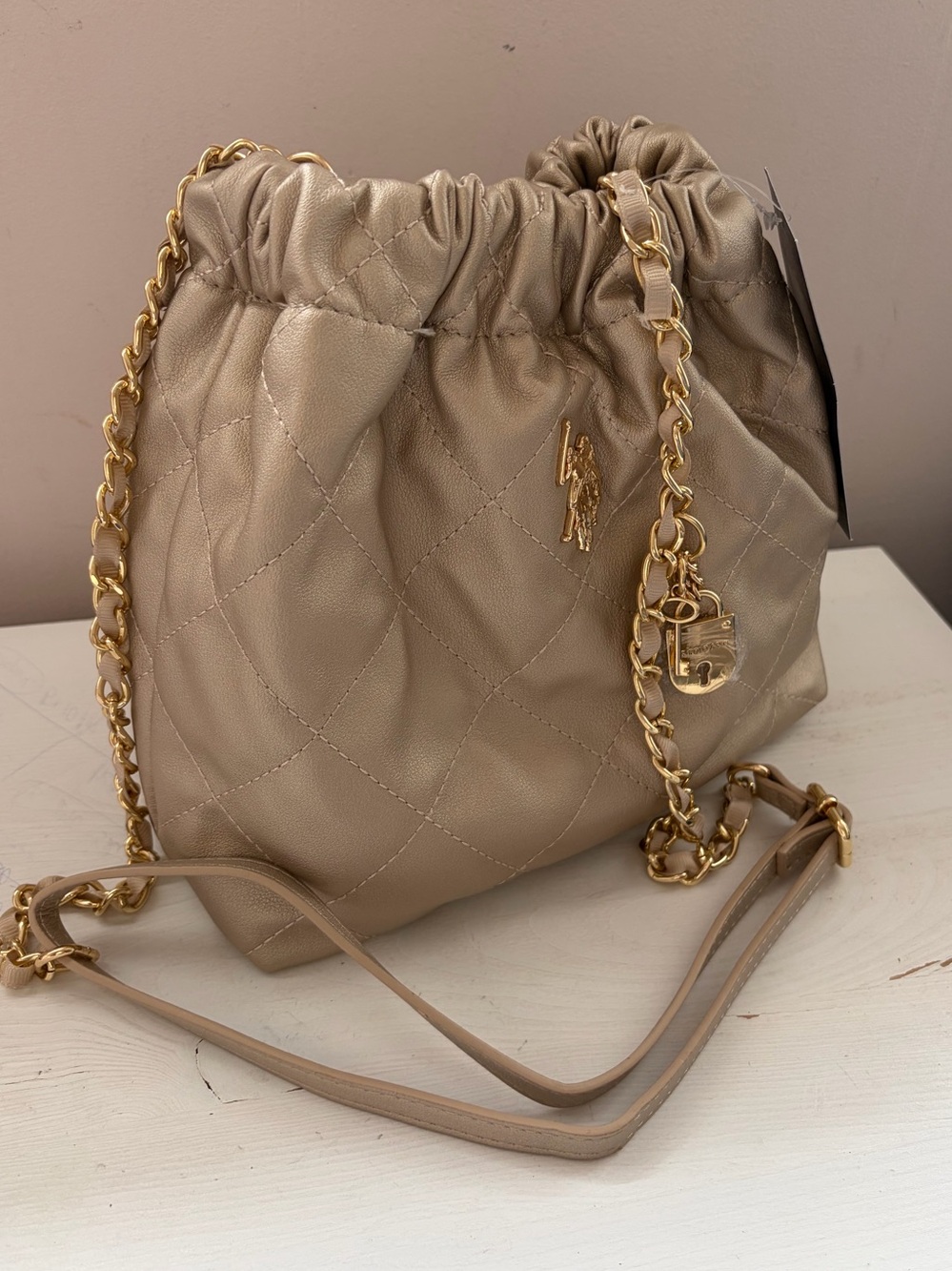 U.S. Polo Assn. Metallic Champagne Quilted Drawstring Bucket Bag